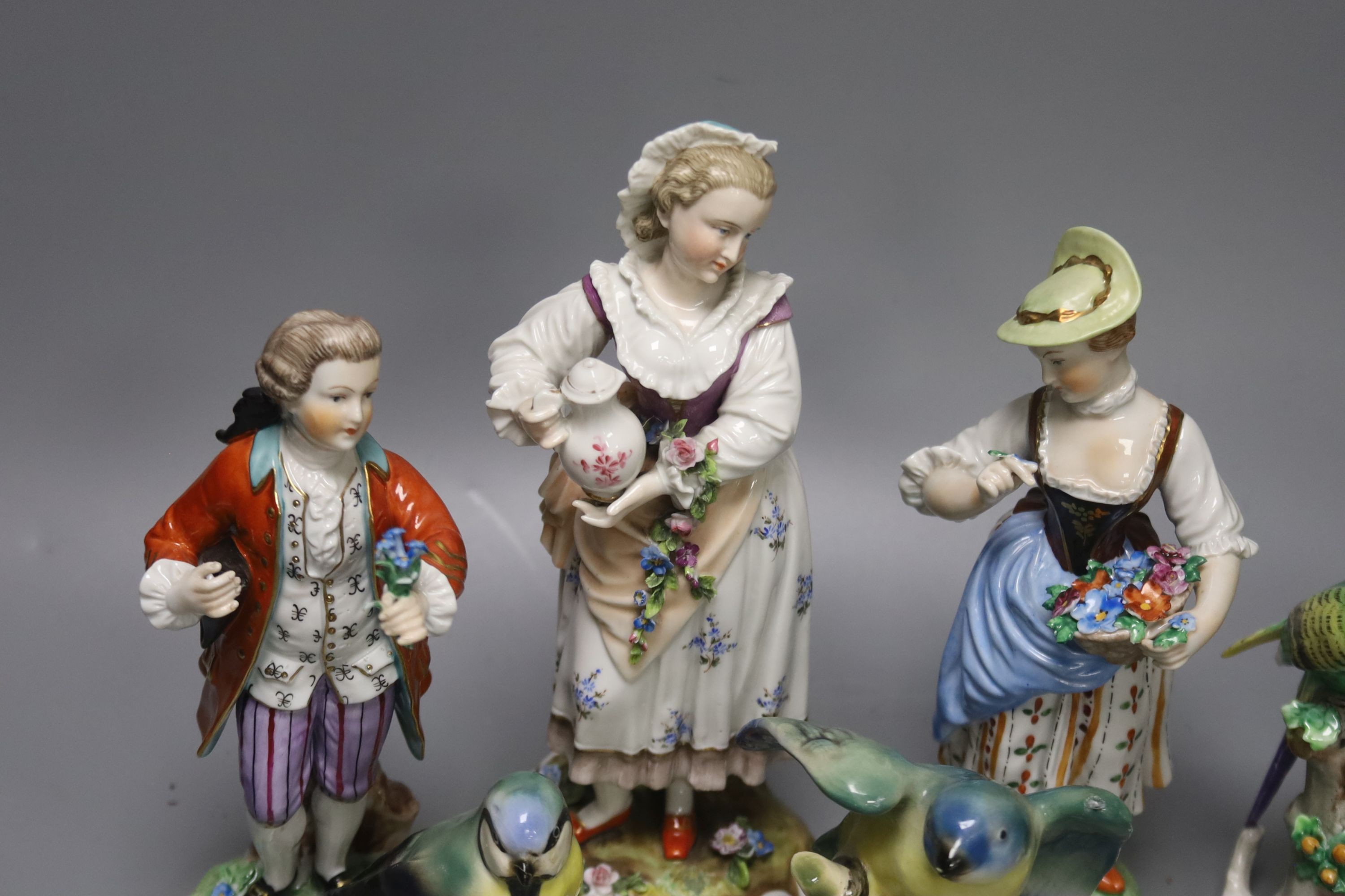Three Continental figures and a collection of bird ornaments, tallest 22cm